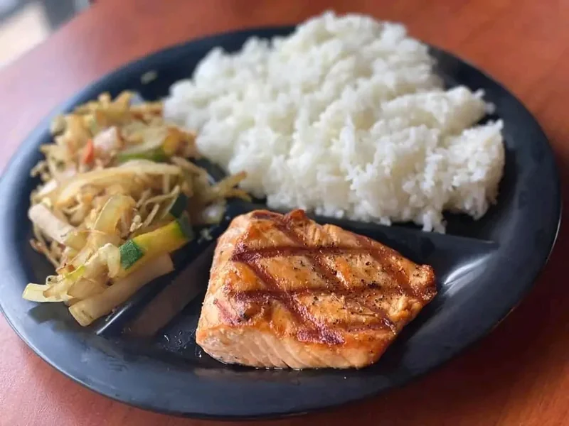 Grilled teriyaki salmon fillet with steamed rice and hibachi vegetables