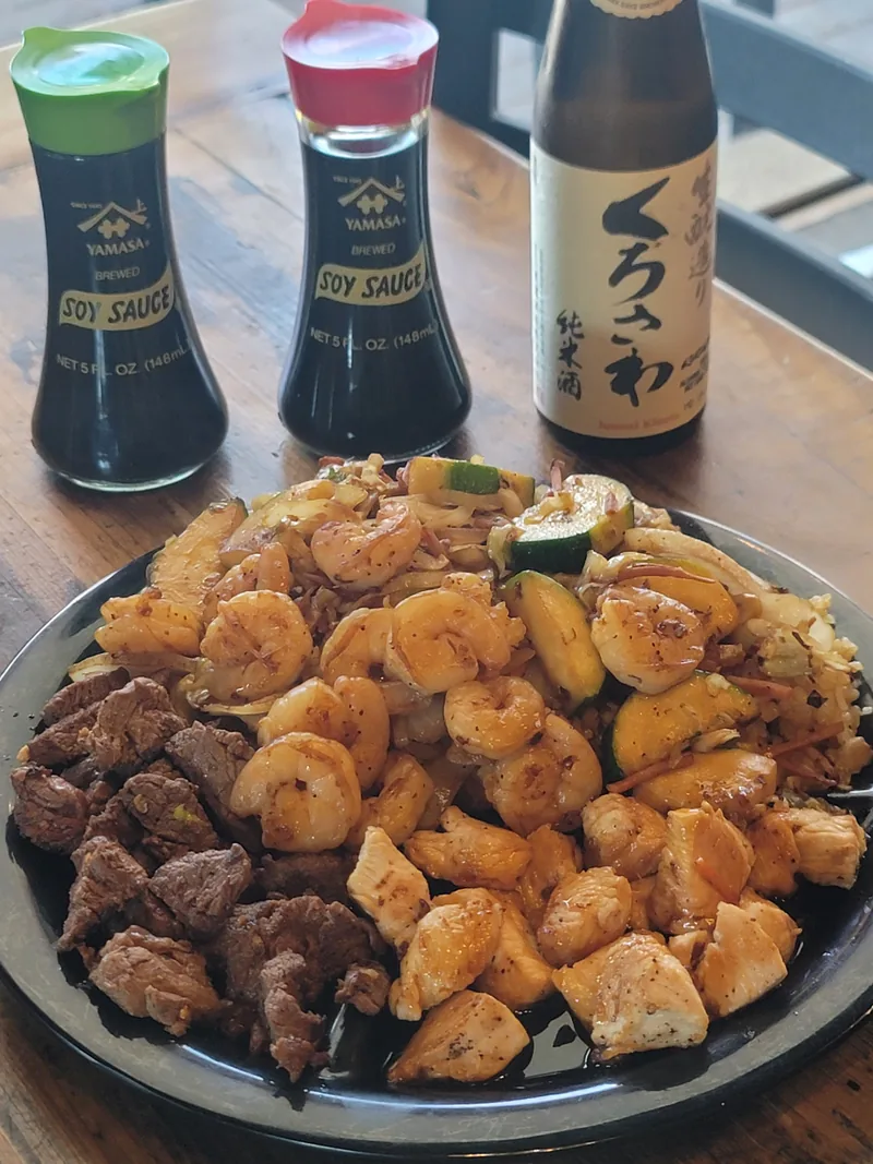 Hibachi platter of chicken, shrimp and steak over grilled vegetables and rice