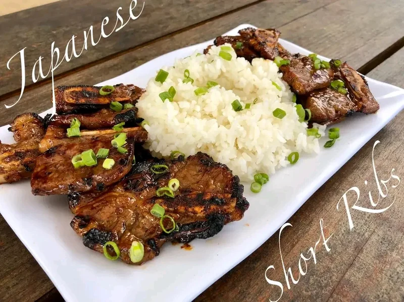 Grilled and glazed Japanese beef short ribs with scallions and steamed rice